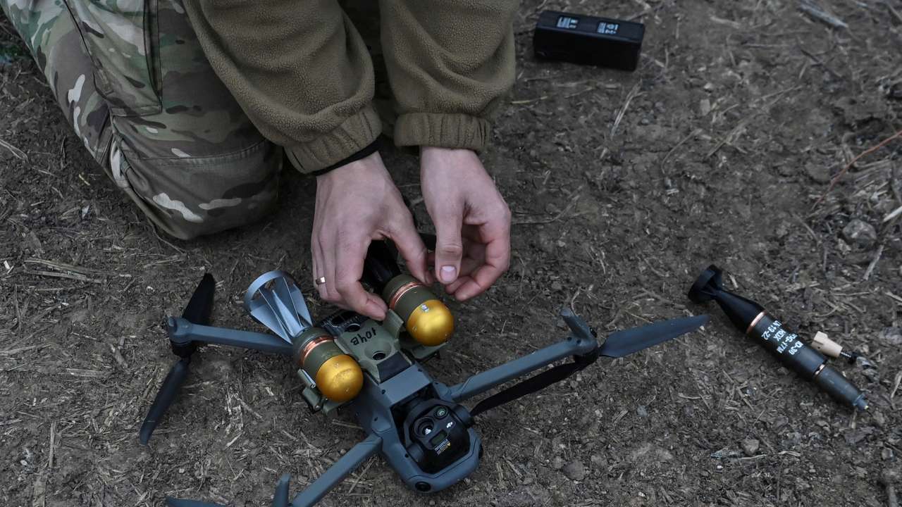 FILE PHOTO: Policeman of the 'Khyzhak' Brigade attaches custom miniature drop bombs to a drone at a position in a front line near the town of Toretsk
