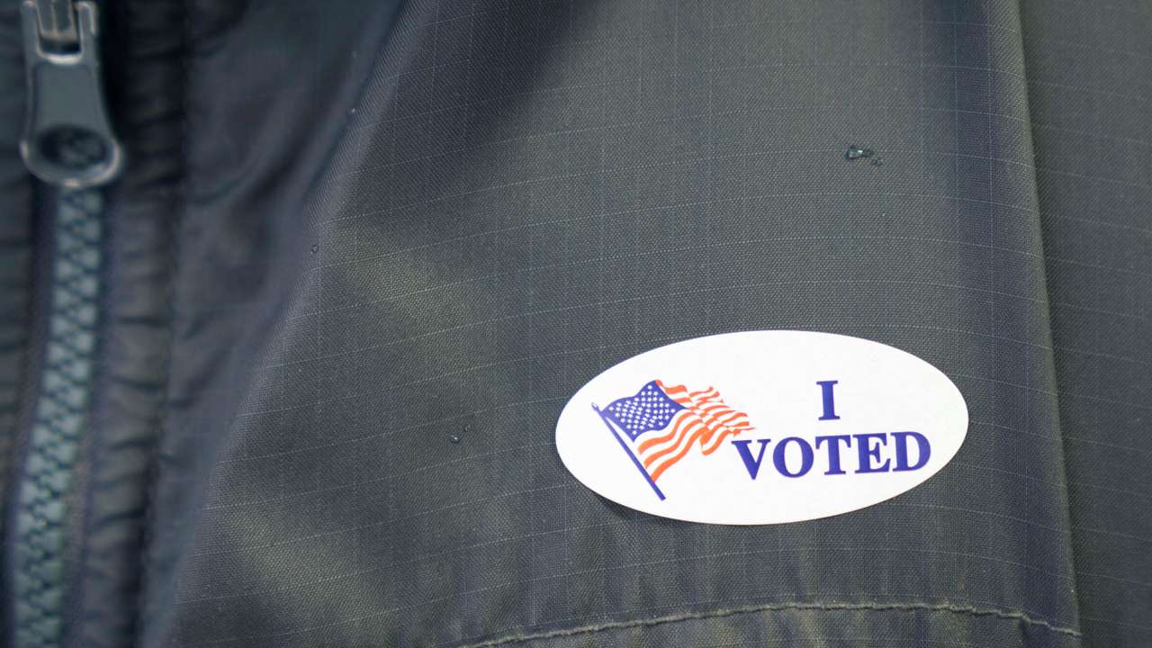 A file photo of a voter wearing an 'I voted' sticker at a polling station