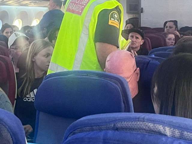 A paramedic walks onboard after an incident on a LATAM Airlines Boeing 787, in Auckland