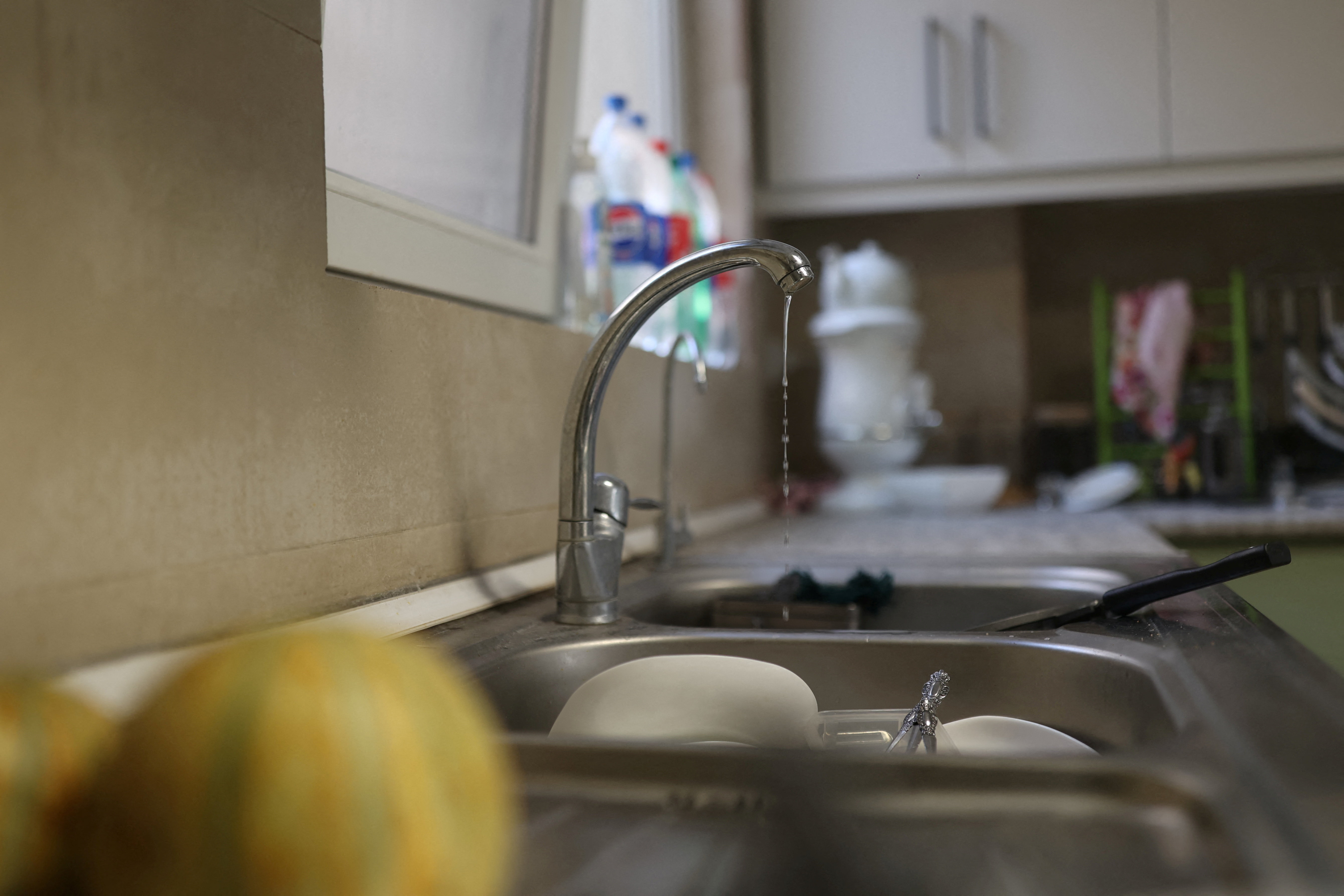 A small amount of water pours out of the faucet following a drought crisis in Tehran
