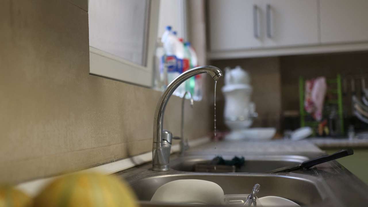 A small amount of water pours out of the faucet following a drought crisis in Tehran