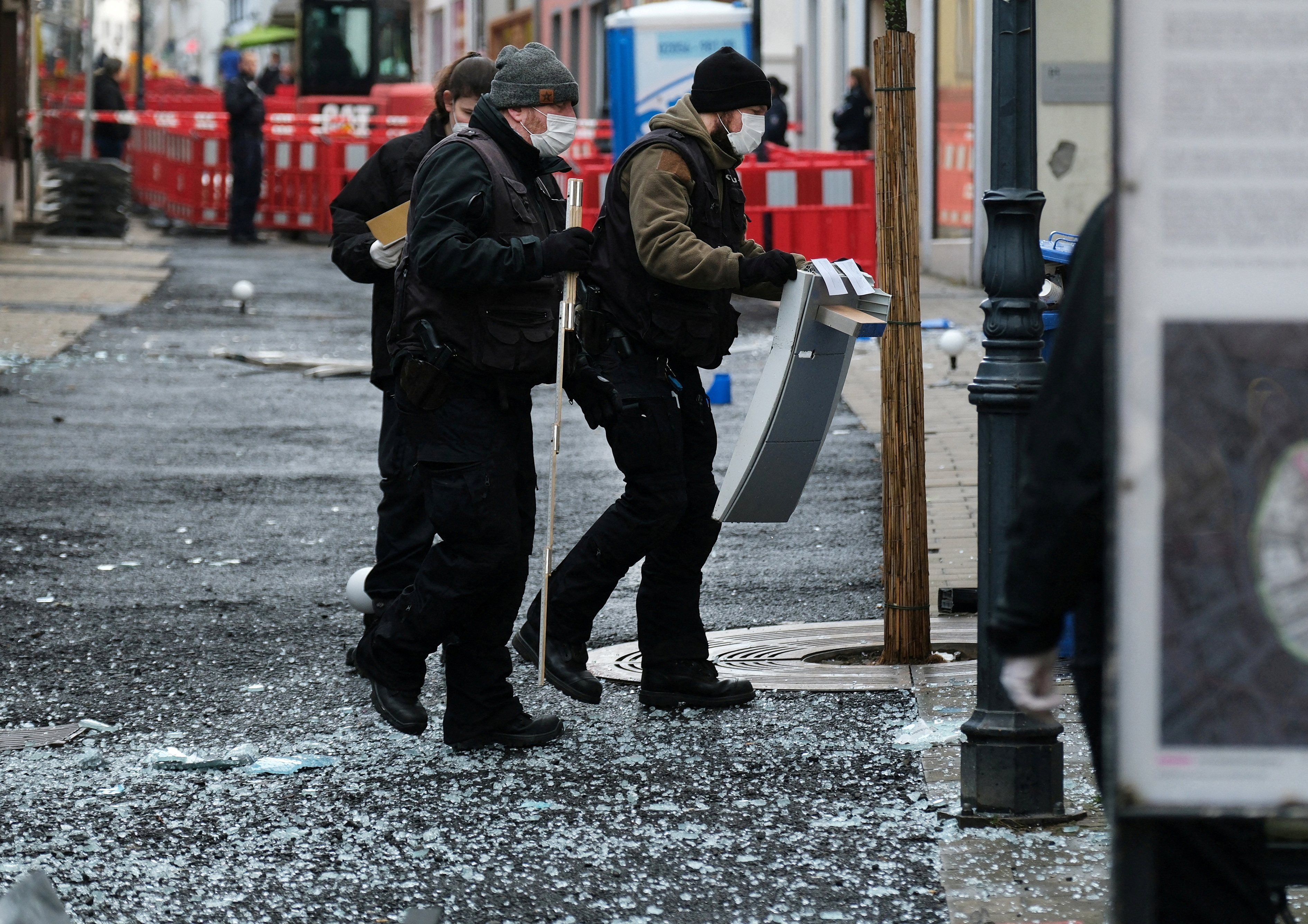 FILE PHOTO: Law enforcement officers investigate the scene following an attack on bank ATMs in Ratingen