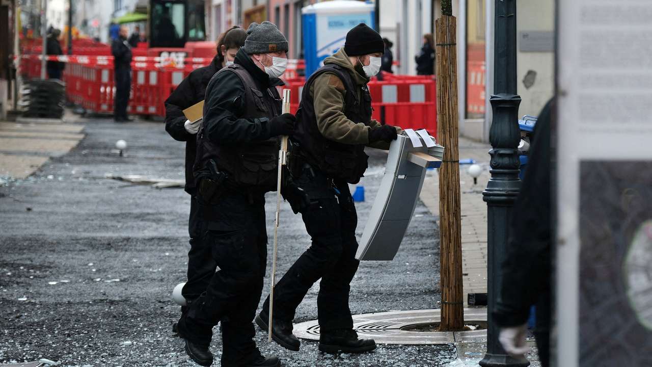 FILE PHOTO: Law enforcement officers investigate the scene following an attack on bank ATMs in Ratingen