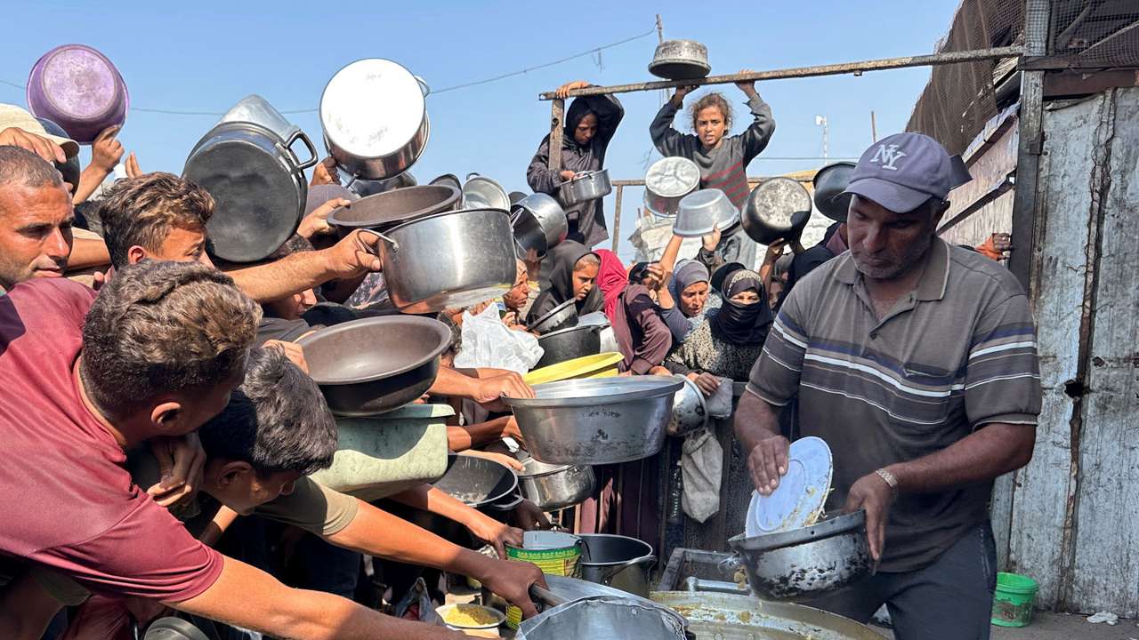 Palestinians gather to receive food from a charity kitchen amid a ceasefire between Israel and Hamas, in Khan Younis