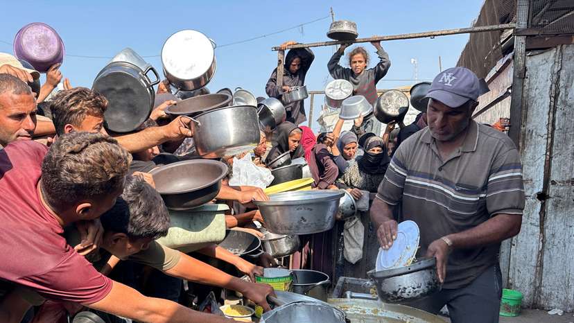 Palestinians gather to receive food from a charity kitchen amid a ceasefire between Israel and Hamas, in Khan Younis