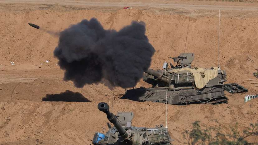 An Israeli self-propelled artillery unit fires as seen from southern Israel