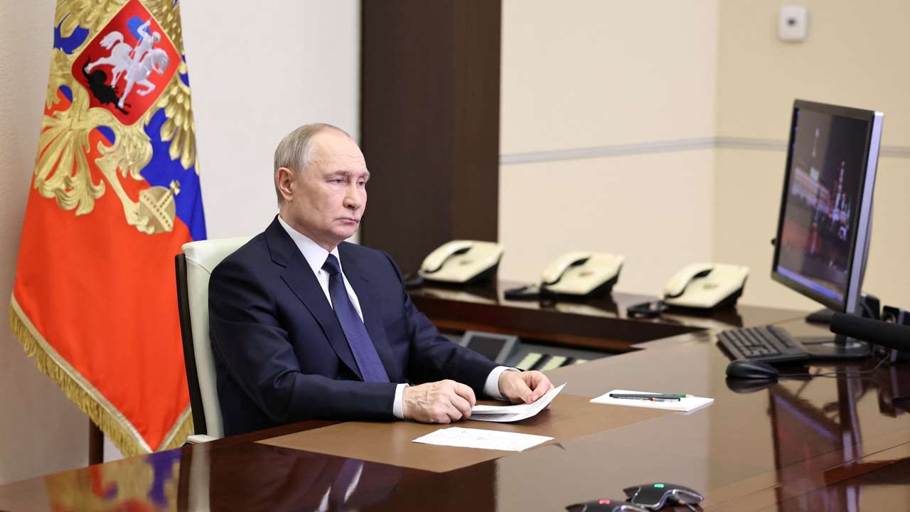 Russian President Putin listens to a report of Chief of the General Staff of Russian Armed Forces Gerasimov, outside Moscow