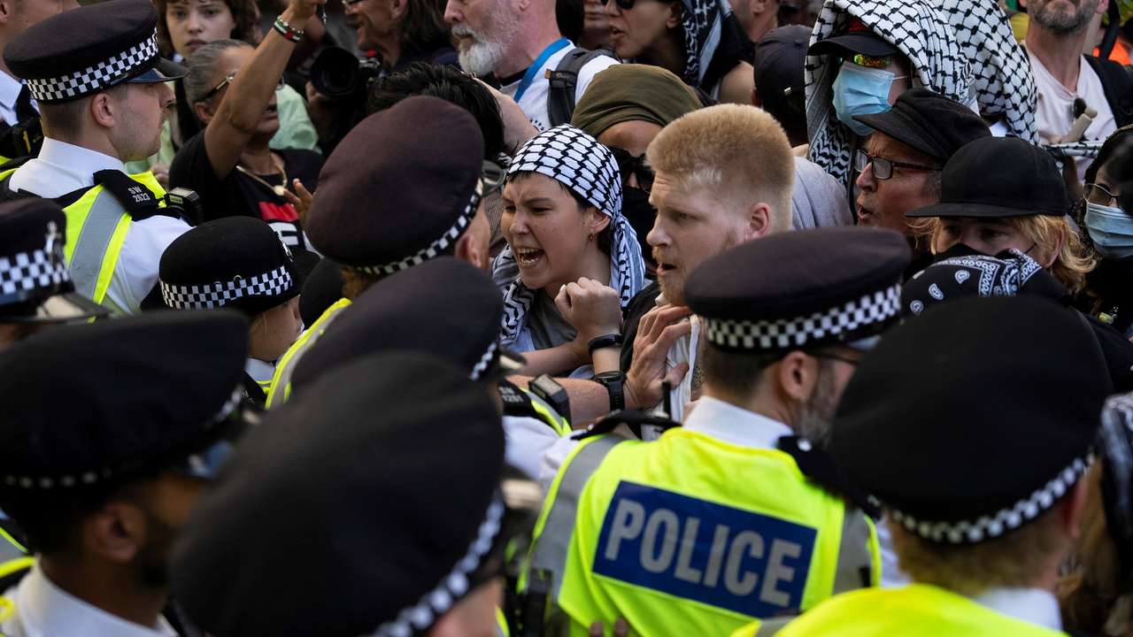 Supporters of the pro-Palestinian group Palestine Action scuffle with police officers outside the High Court in London