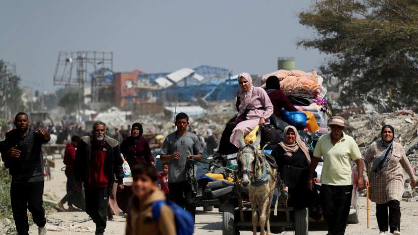 Palestinians make their way to flee their homes, in the northern Gaza Strip