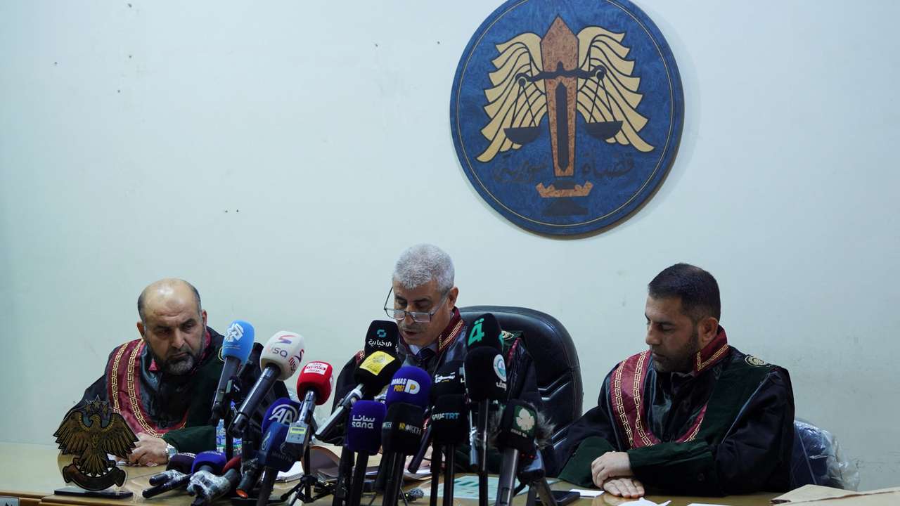 A judge speaks during the trial at the Palace of Justice in Aleppo