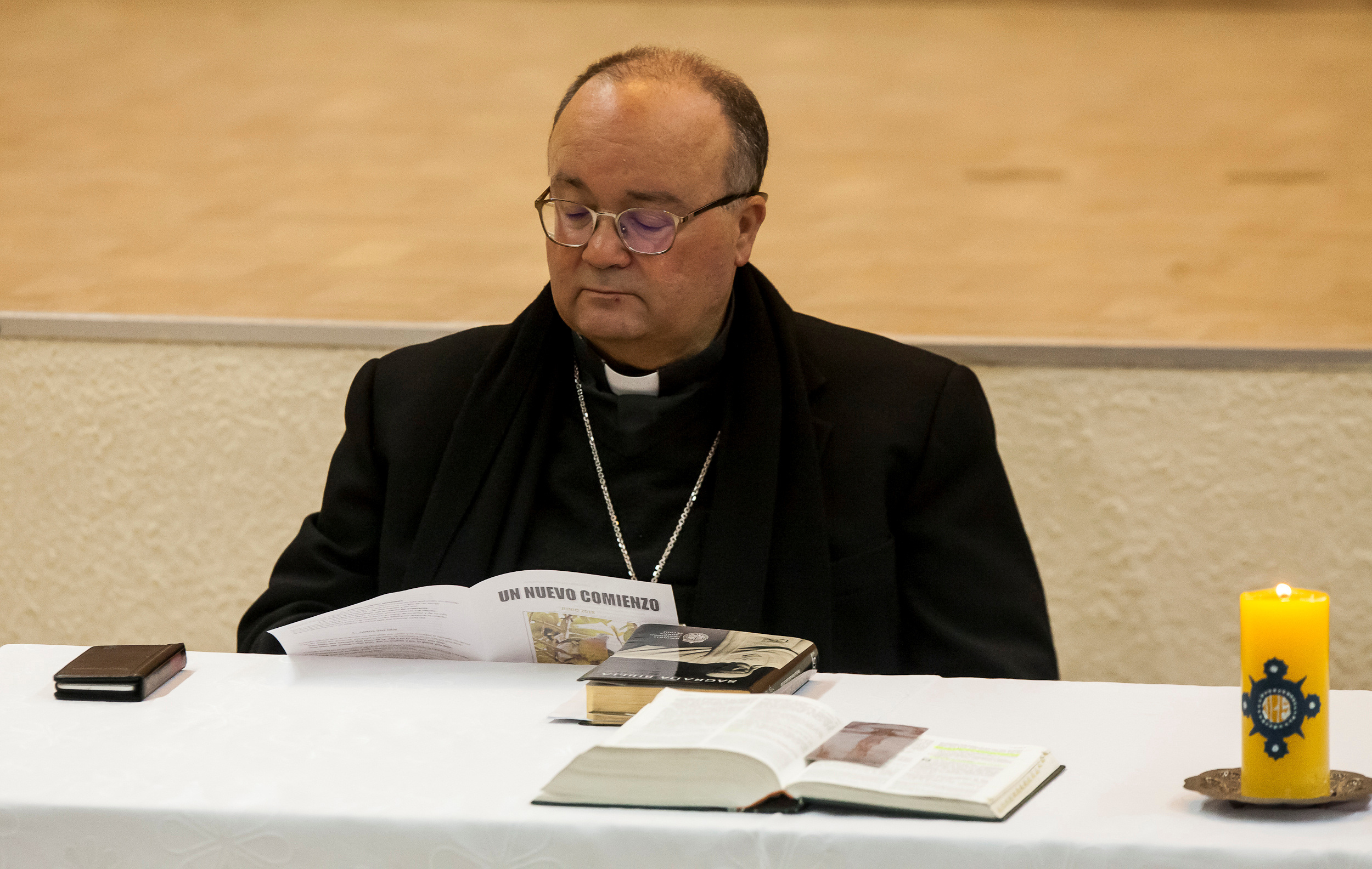 Special Vatican envoys, archbishop Charles Scicluna reads a brochure  entitled "A new beginning",  during a meeting with priests inside a church in Osorno