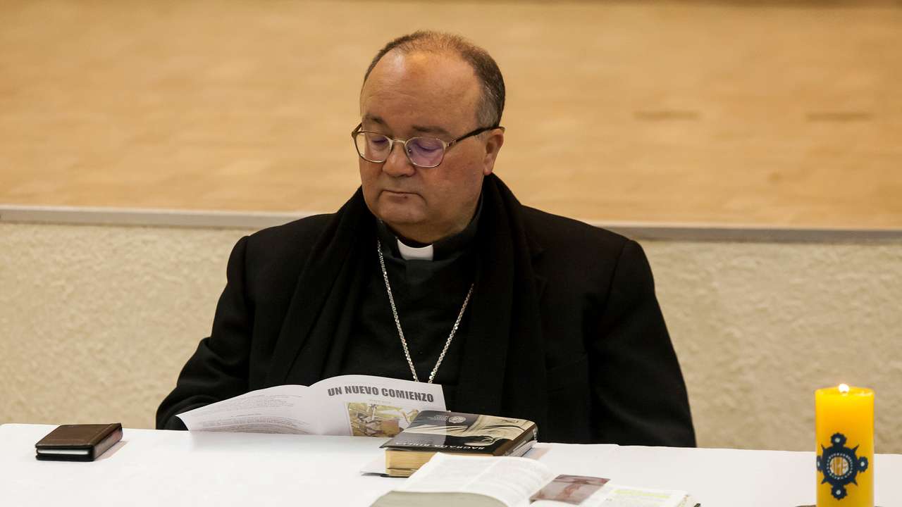 Special Vatican envoys, archbishop Charles Scicluna reads a brochure entitled "A new beginning", during a meeting with priests inside a church in Osorno