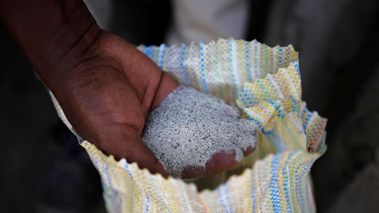 FILE PHOTO: A man displays a coltan ore at the SMB mine near the town of Rubaya