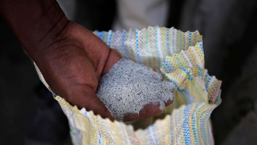 FILE PHOTO: A man displays a coltan ore at the SMB mine near the town of Rubaya