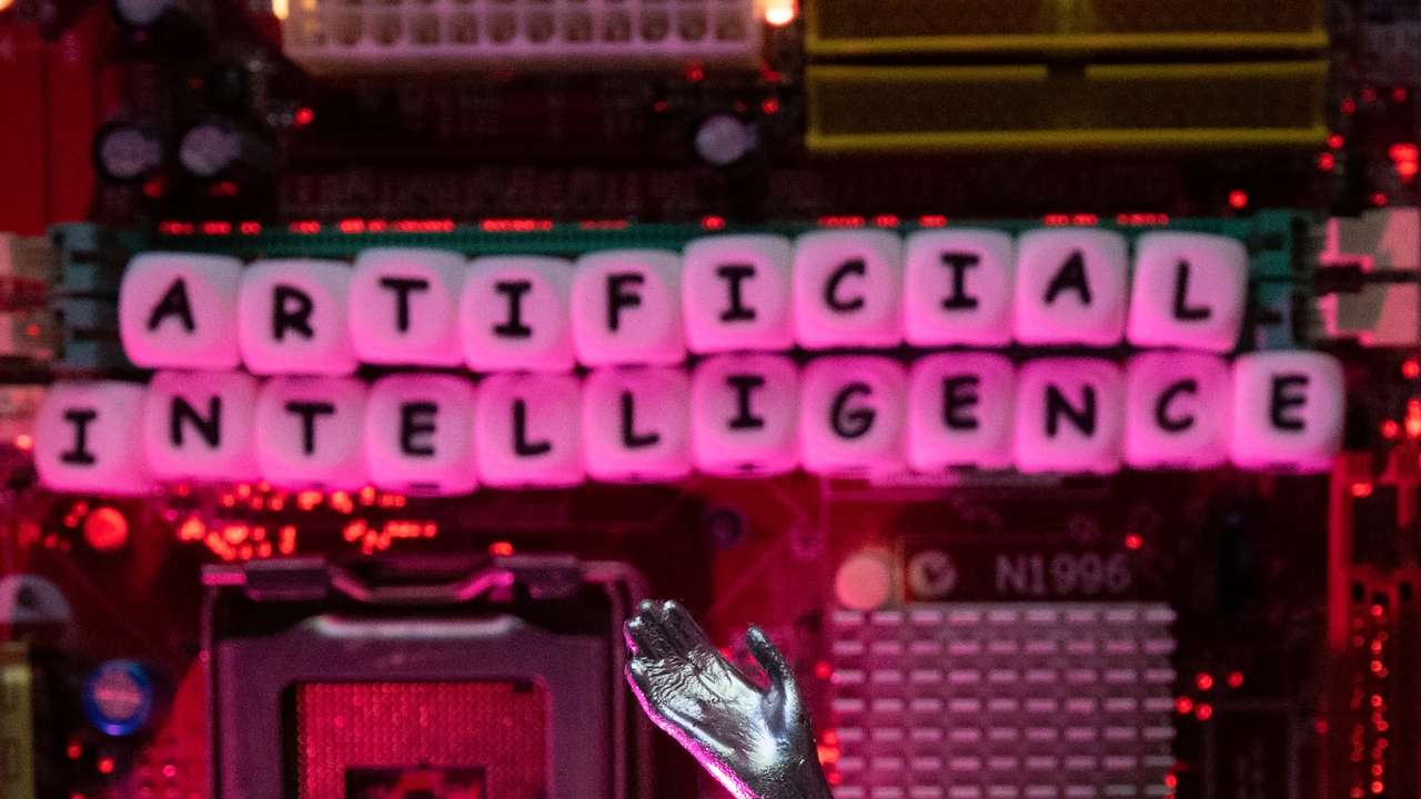 Illustration shows AI (Artificial Intelligence) letters and robot hand