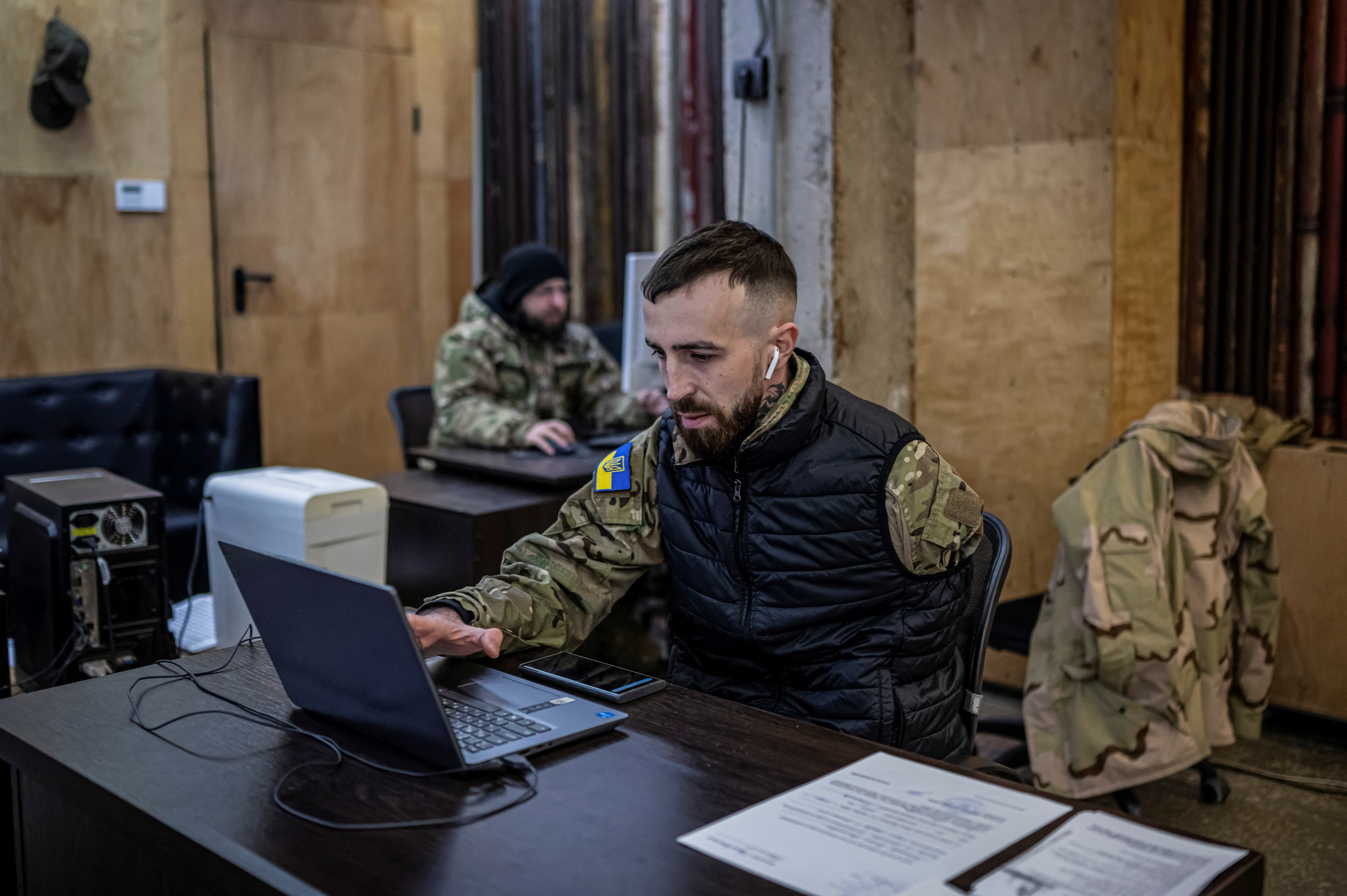 A recruitment officer waits for volunteers who aspires to join the 3rd Separate Assault Brigade of the Ukrainian Armed Forces at an undisclosed location in the Kyiv region