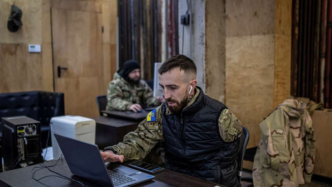 A recruitment officer waits for volunteers who aspires to join the 3rd Separate Assault Brigade of the Ukrainian Armed Forces at an undisclosed location in the Kyiv region