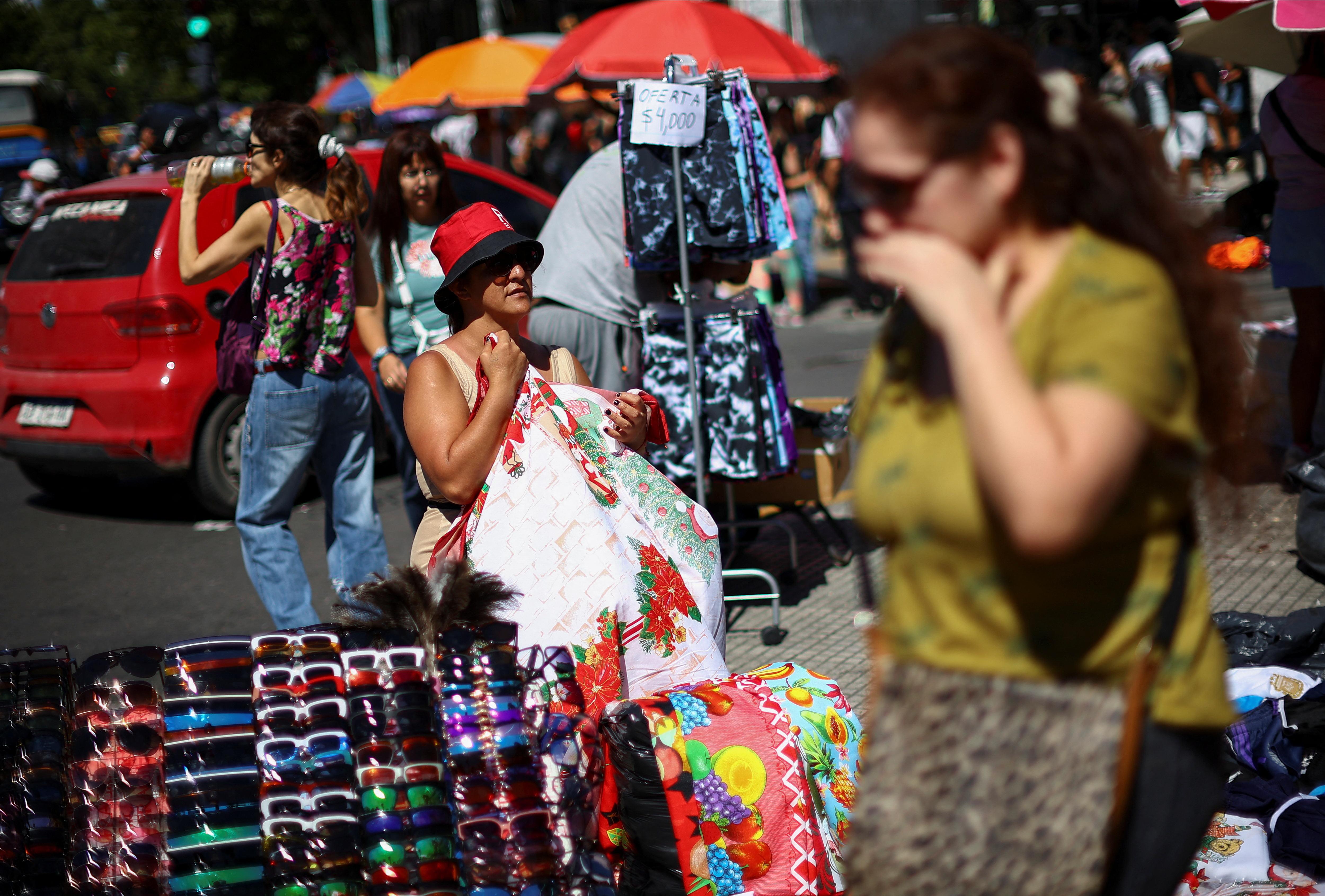 People shop before Christmas at a street market, in Buenos Aires