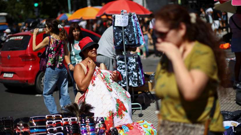 People shop before Christmas at a street market, in Buenos Aires