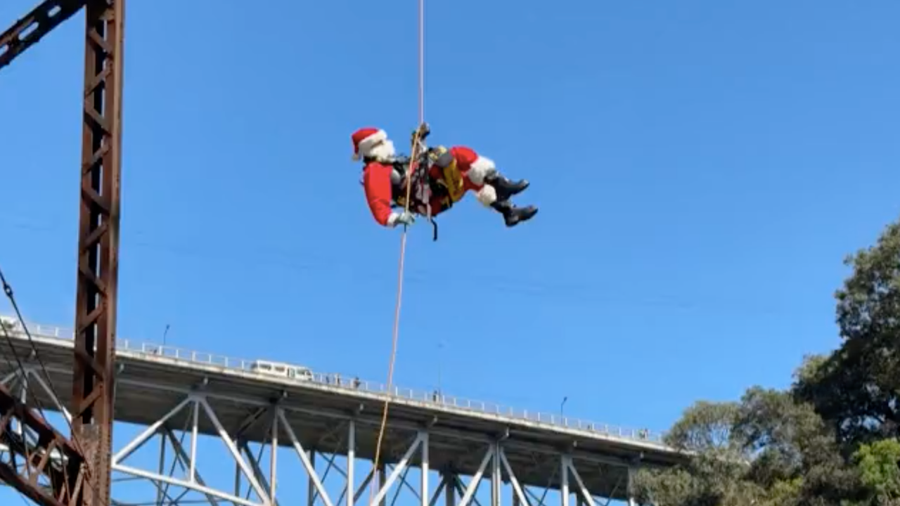 Guatemalan firefighter dressed as Santa delivers presents in low-income neighbourhoods