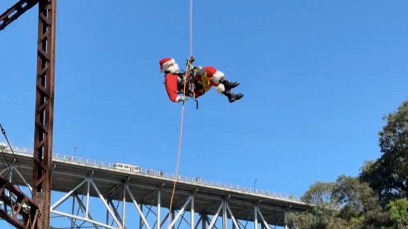 Guatemalan firefighter dressed as Santa delivers presents in low-income neighbourhoods