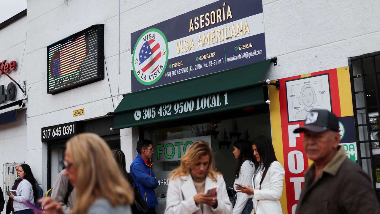 People who had an appointment scheduled for the visa process to the United States and were cancelled, wait outside the United States embassy, in Bogota