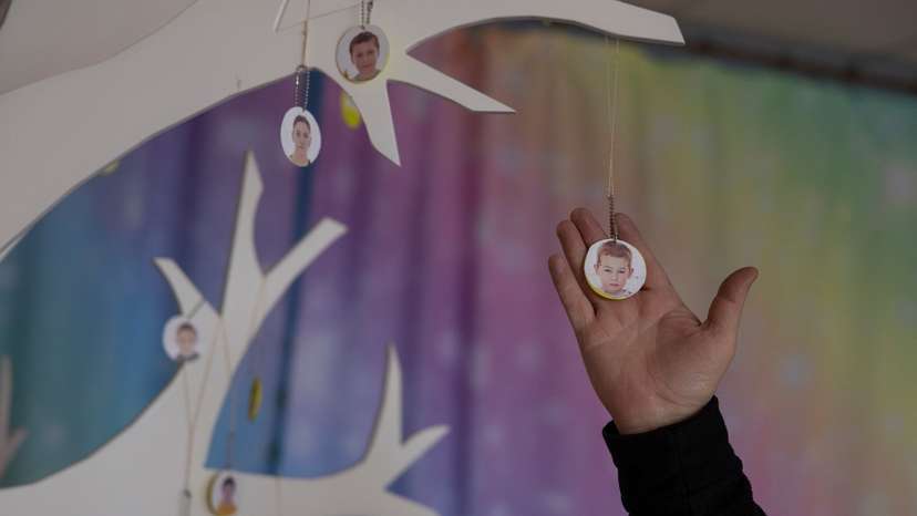Volodymyr Sahaidak shows a portrait of a boy whom he hid with other children during a Russian occupation, in outskirt of Kherson