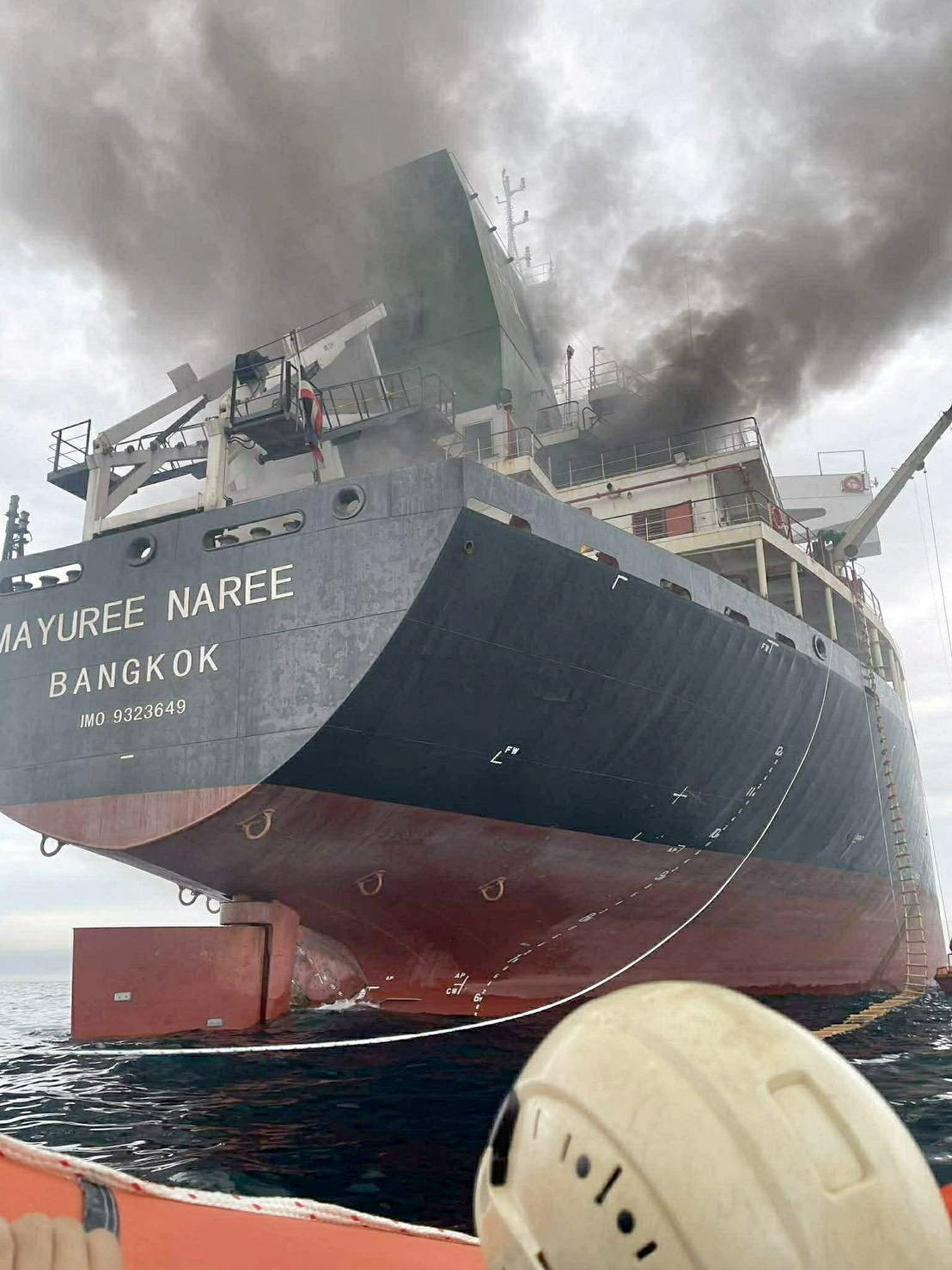 The Thailand-flagged cargo ship Mayuree Naree engulfed in black smoke in the Strait of Hormuz