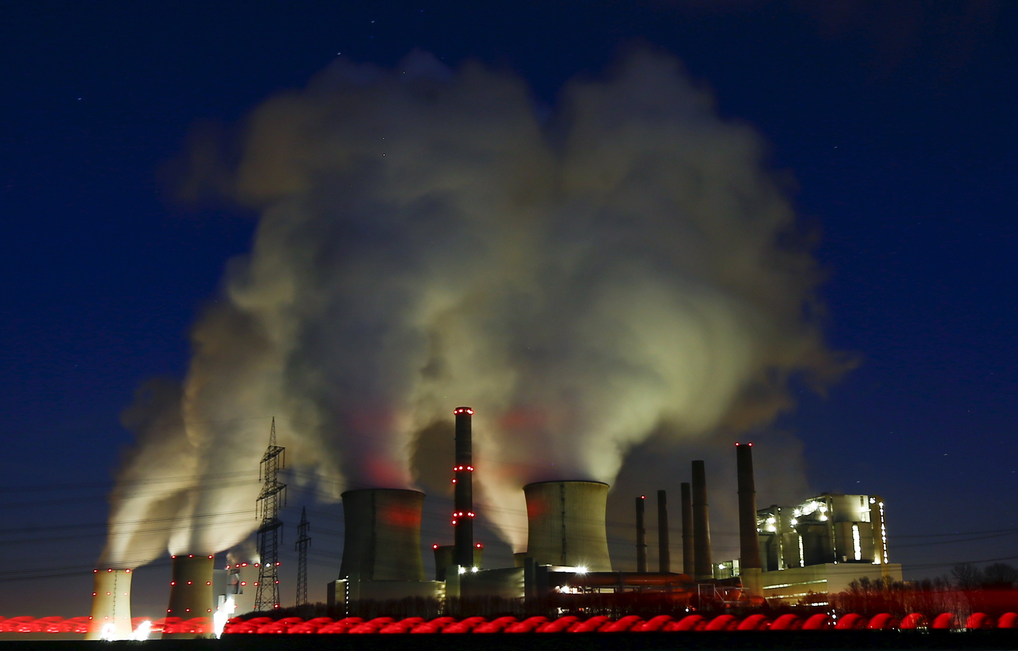 Steam rises from the chimneys of the coal power plant of RWE Power in Neurath