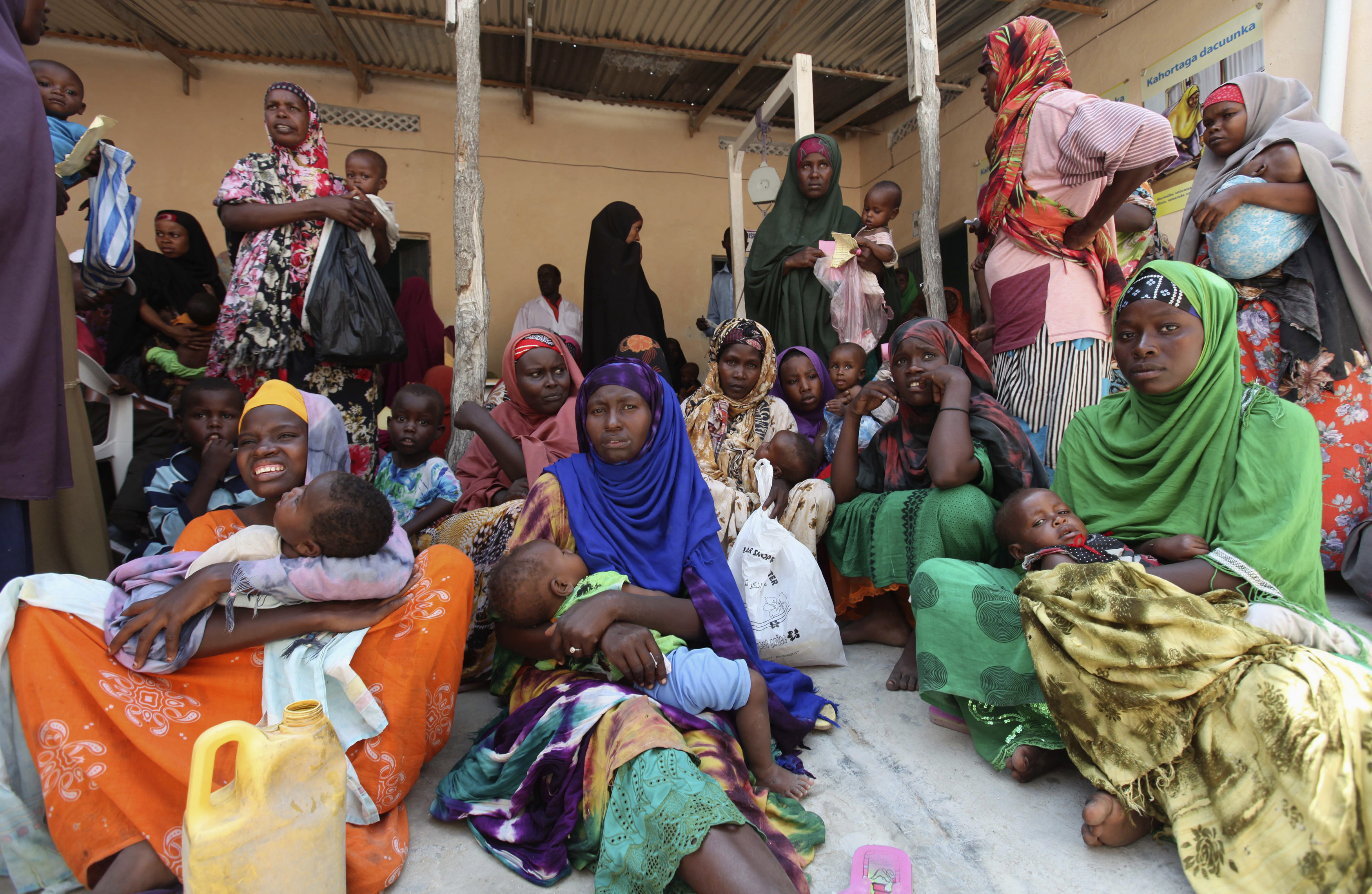 Internally displaced Somali women wait for medicine at Save the Children UK clinic at their camp in Hodan district of Somalia's capital Mogadishu