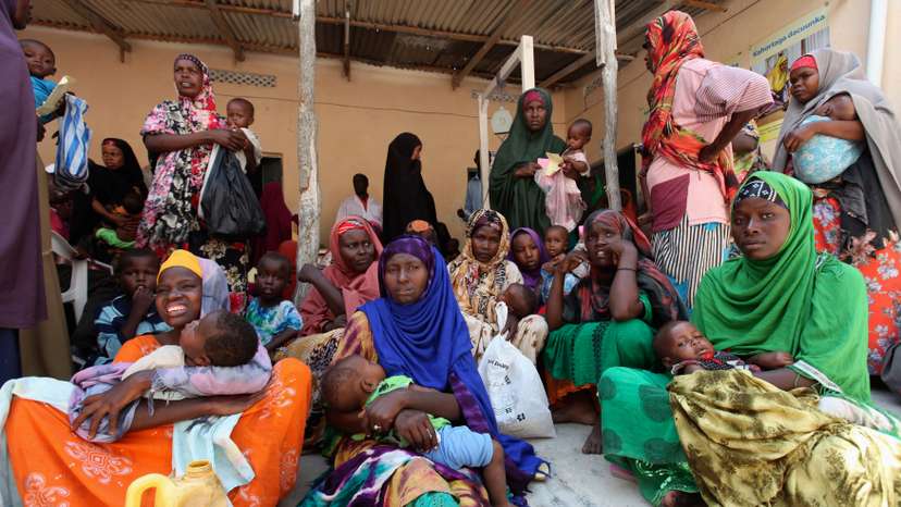 Internally displaced Somali women wait for medicine at Save the Children UK clinic at their camp in Hodan district of Somalia's capital Mogadishu