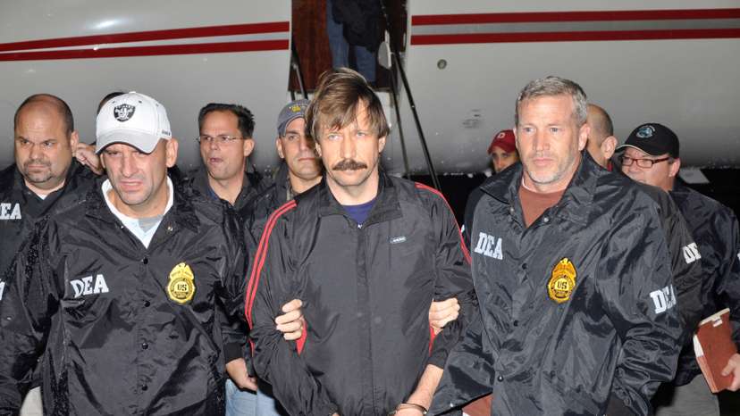 FILE PHOTO: FILE PHOTO: File handout image shows suspected Russian arms dealer Bout is escorted by DEA officers after arriving in New York