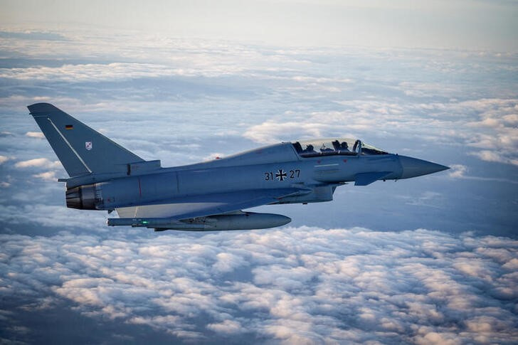 FILE PHOTO: A Eurofighter jet accompanies the flight of German Chancellor Olaf Scholz