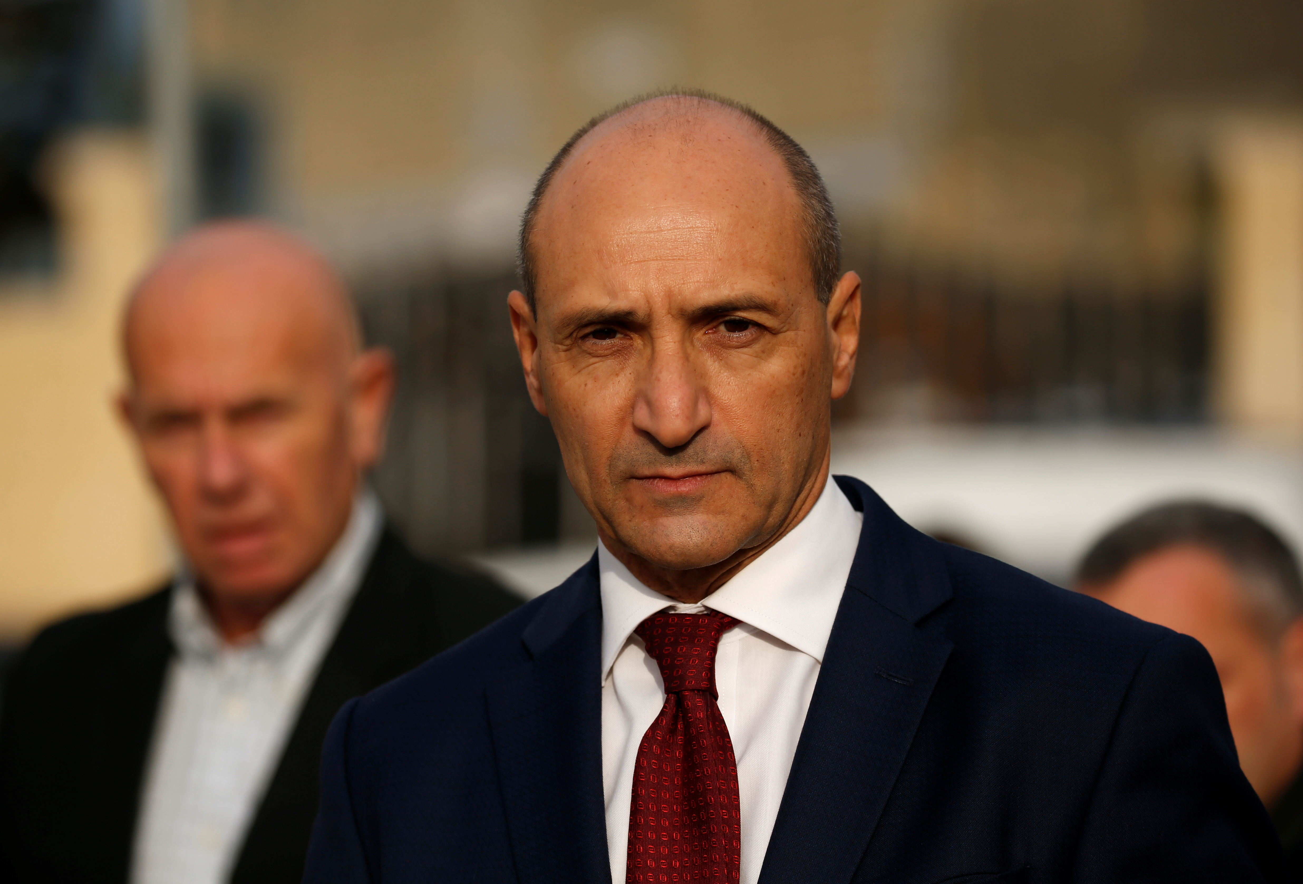 Maltese Health Minister Chris Fearne looks on as he talks to the media after a fire destroyed part of a reception centre for migrants in Marsa