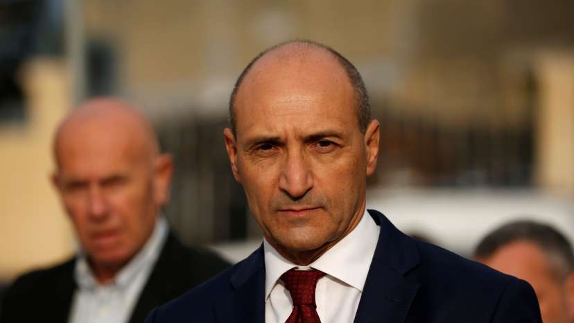 Maltese Health Minister Chris Fearne looks on as he talks to the media after a fire destroyed part of a reception centre for migrants in Marsa