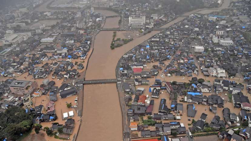 An aerial view taken by a helicopter shows flooded residential area caused by a torrential rain in Wajima