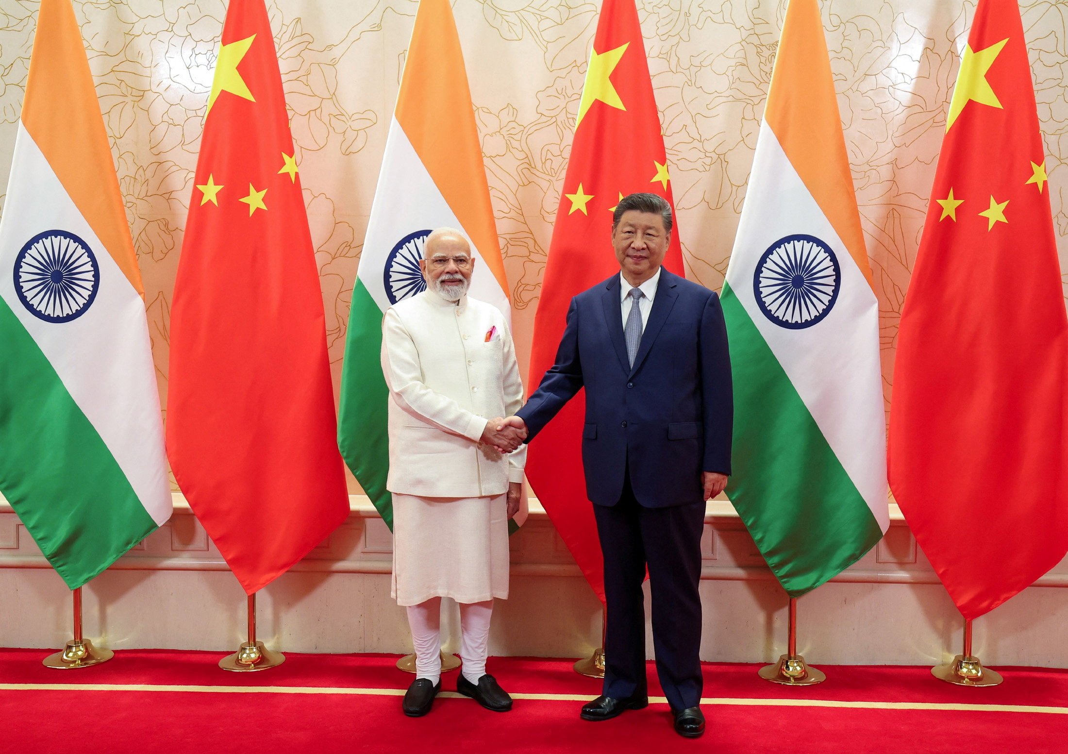 India's PM Modi shakes hands with Chinese President Xi Jinping during a meeting in Tianjin