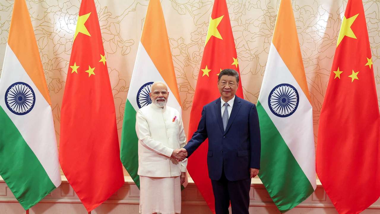 India's PM Modi shakes hands with Chinese President Xi Jinping during a meeting in Tianjin