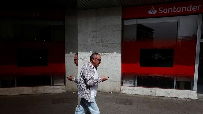 A man walks past a Santander bank branch in Madrid