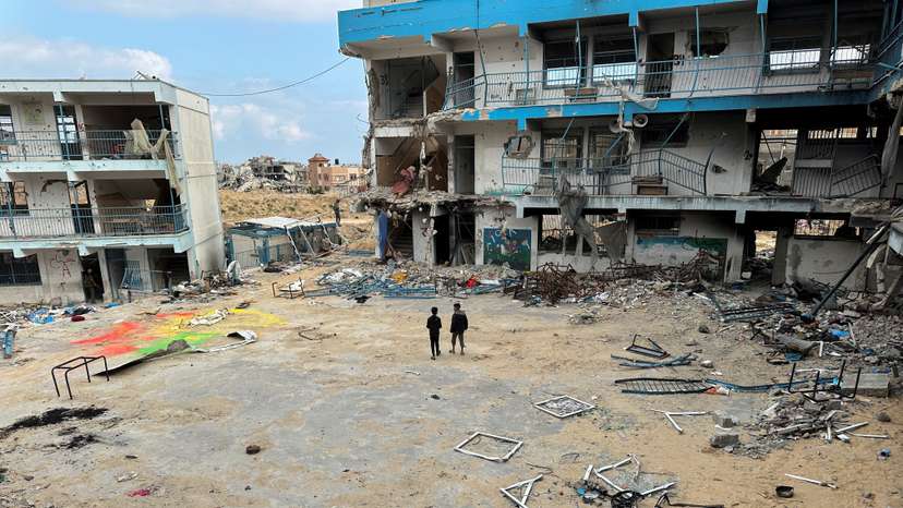 Palestinian children inspect their destroyed school in the southern Gaza Strip