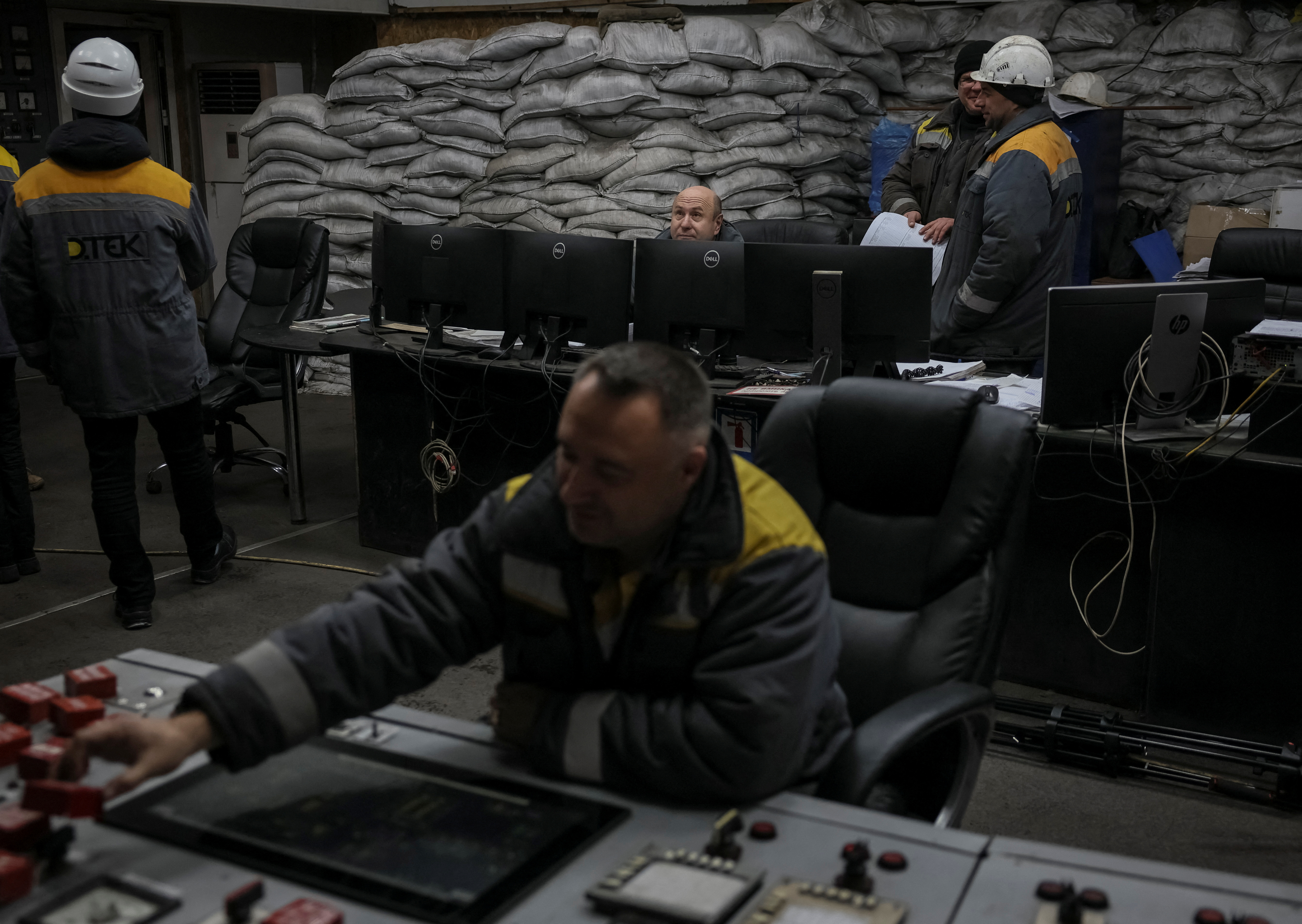Employees work in a control centre of the thermal power plant damaged by Russian missile strike in an undisclosed location of Ukraine