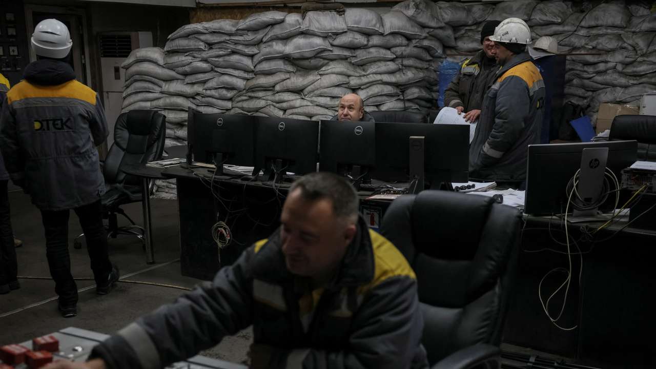 Employees work in a control centre of the thermal power plant damaged by Russian missile strike in an undisclosed location of Ukraine