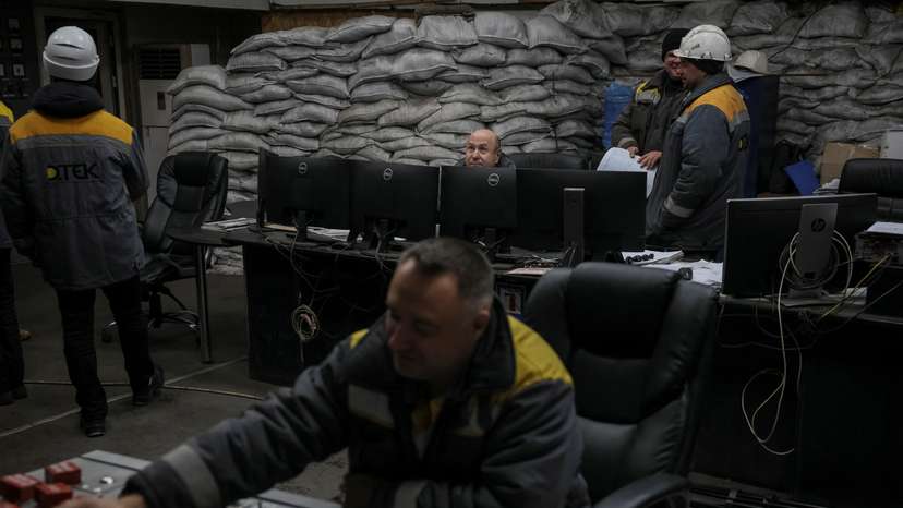 Employees work in a control centre of the thermal power plant damaged by Russian missile strike in an undisclosed location of Ukraine