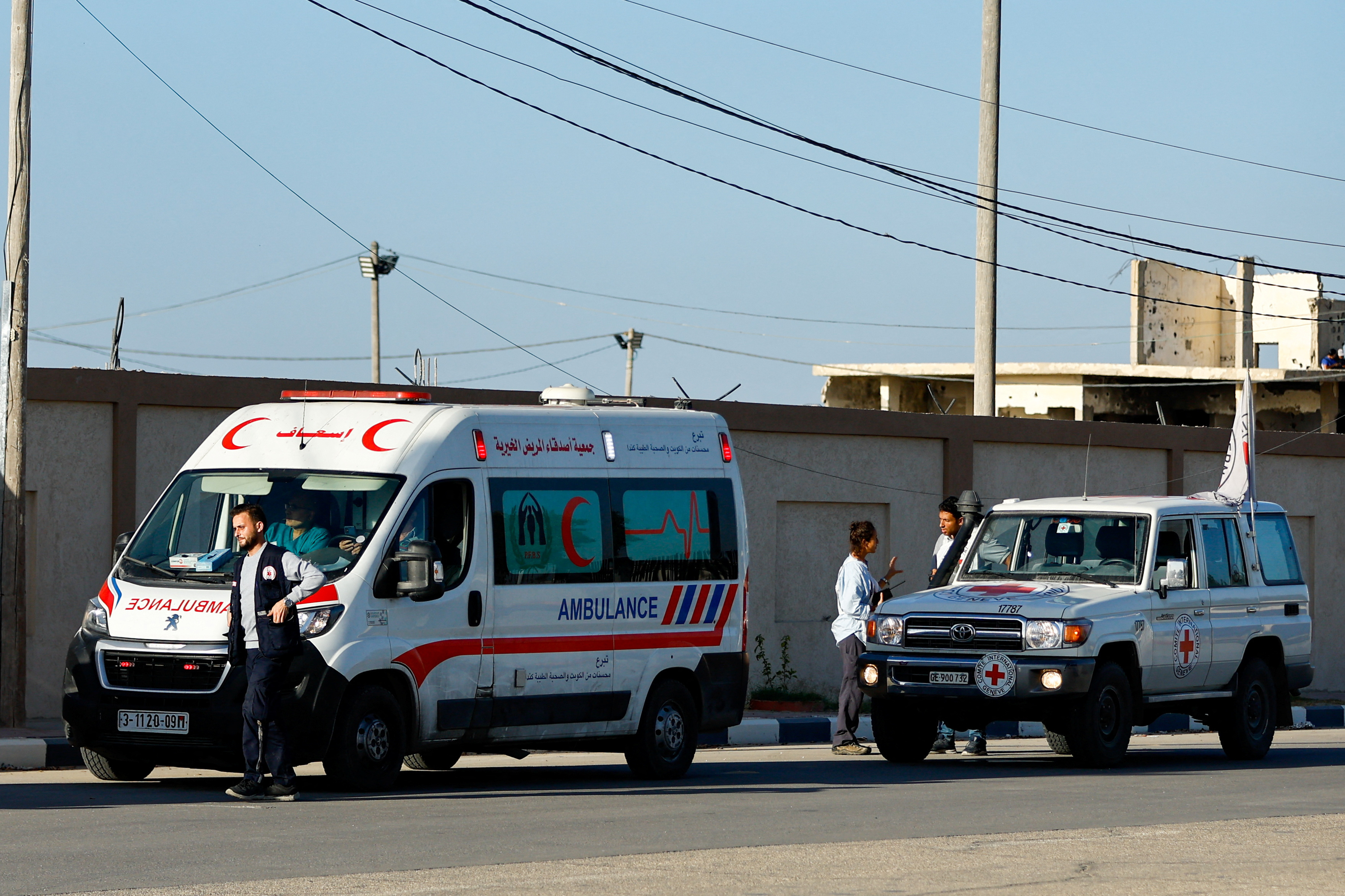 Ambulances wait to move towards the Egyptian side of Rafah crossing