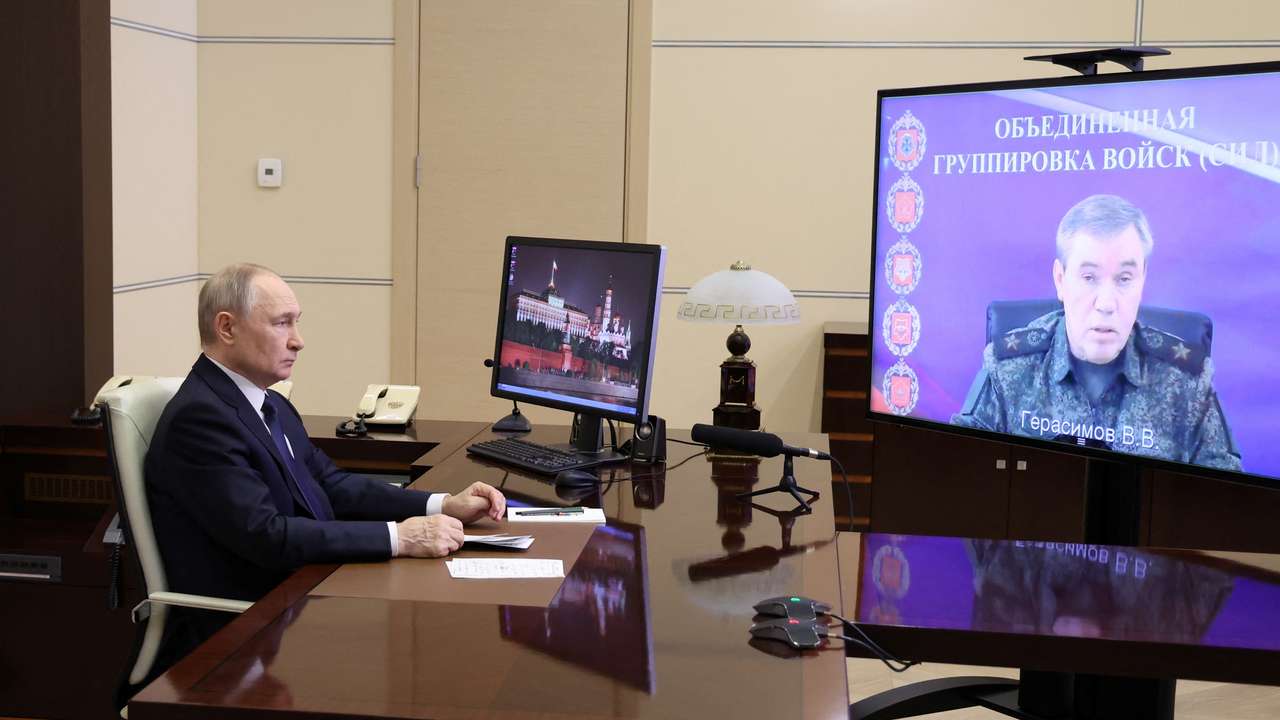 Russian President Putin listens to a report of Chief of the General Staff of Russian Armed Forces Gerasimov, outside Moscow