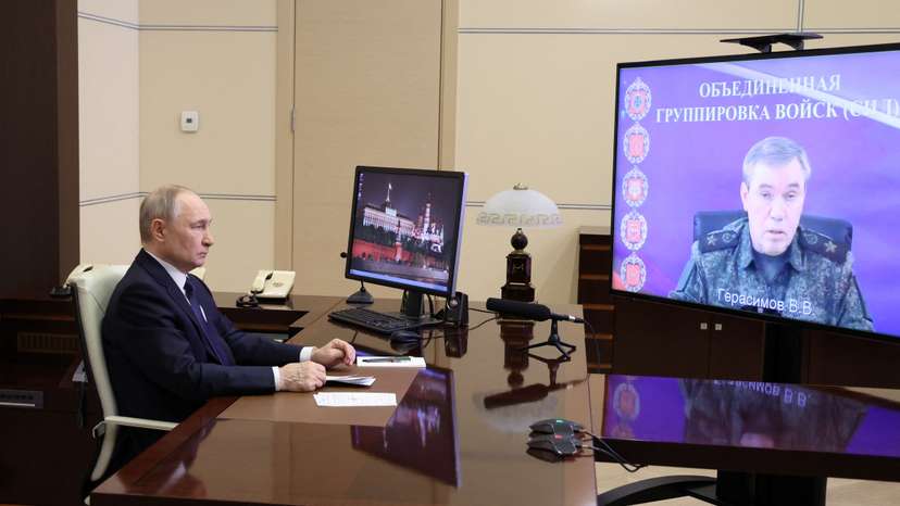 Russian President Putin listens to a report of Chief of the General Staff of Russian Armed Forces Gerasimov, outside Moscow