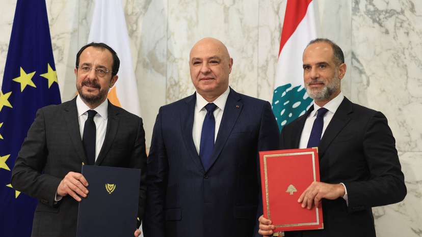 Cyprus' President Nikos Christodoulides and Fayez Rasamny, Lebanese Minister of Public Works and Transport, hold the maritime demarcation agreement documents after signing it, at the presidential palace in Baabda