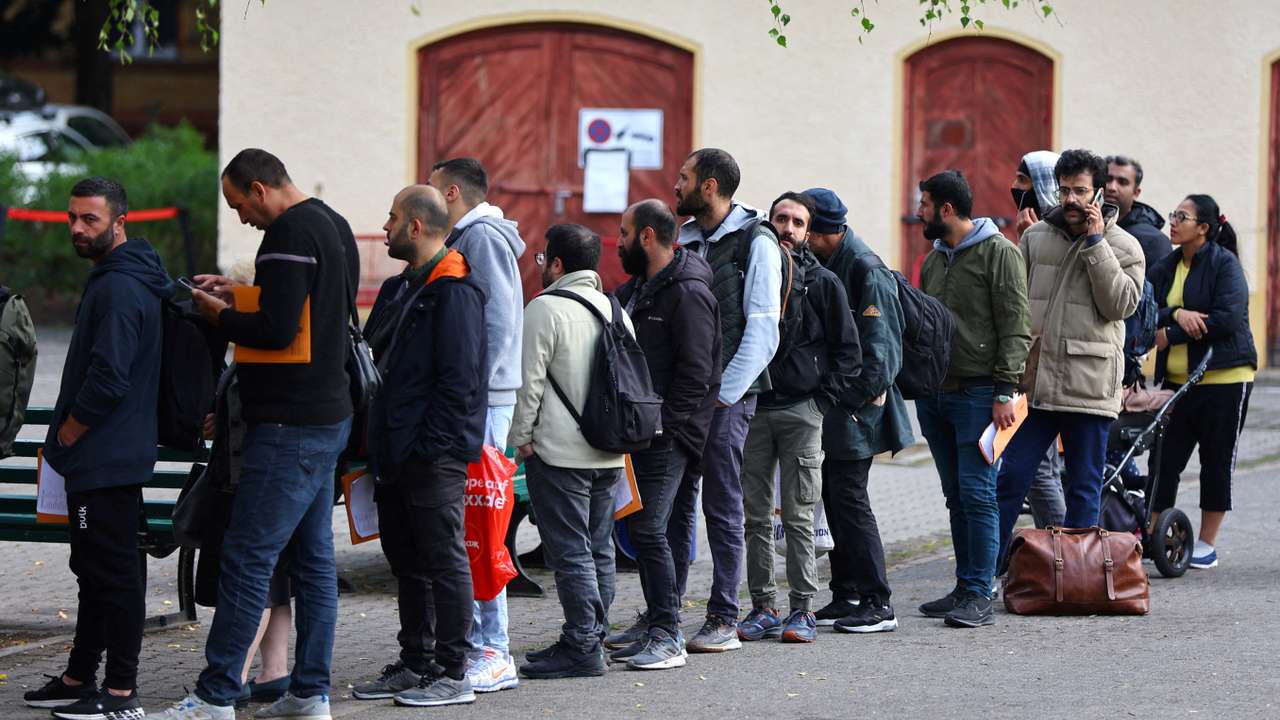FILE PHOTO: Migrants queue at the arrival centre for asylum seekers at Reinickendorf district in Berlin
