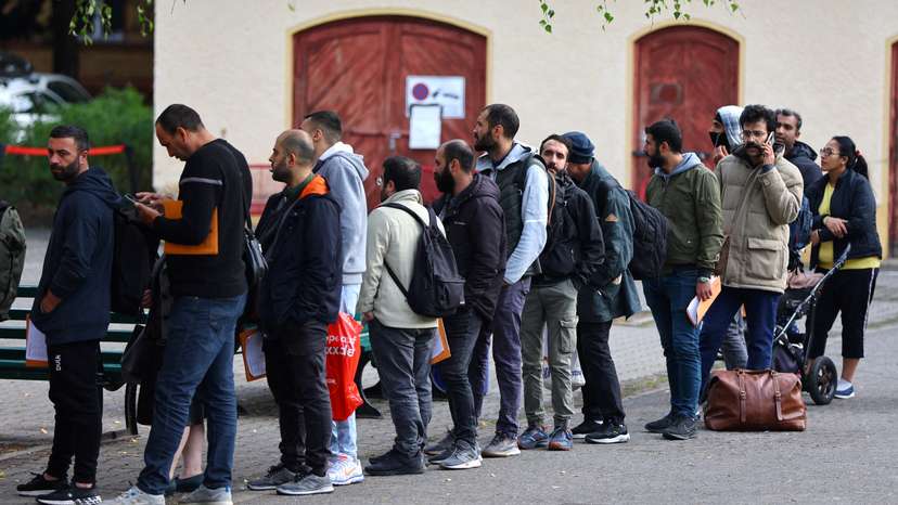 FILE PHOTO: Migrants queue at the arrival centre for asylum seekers at Reinickendorf district in Berlin