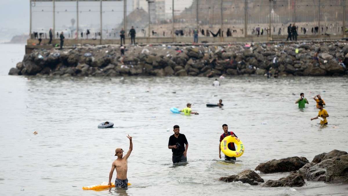Migrantes nadam pelas águas próximas à fronteira com o Marrocos para entrar em Ceuta